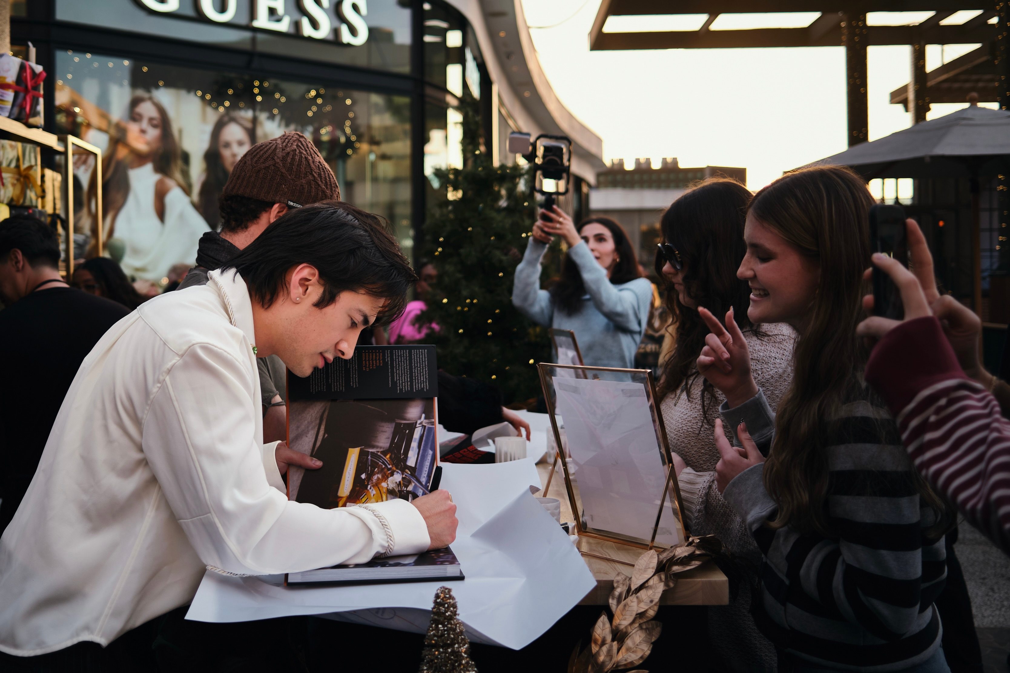 A HBO Max Holiday Wrapping Paper Pop-Up Was Crashed By 'I Love LA' And 'Heated Rivalry' Cast Members To Surprise Fans